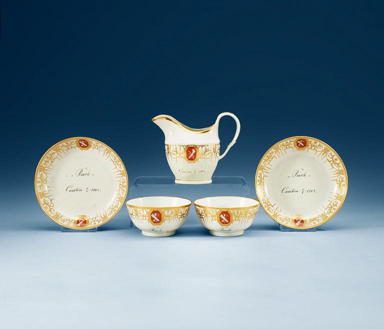 Two armorial tea cups with saucers and a creamer, Qing dynasty, Jiaqing (1796-1820).