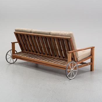 A stained pine garden sofa by Elsa Stackelberg.