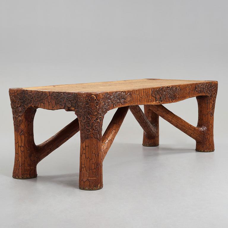 Gustaf Fjaestad, an Art Nouveau carved pine table, Arvika Sweden 1914, a double to the table in the Thiel Collection,