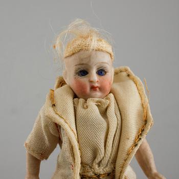 Eight small dolls from the early 20th century.