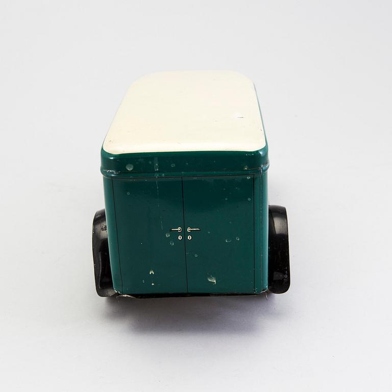 A tinplate biscuit jar in the shape of a truck 1930s.
