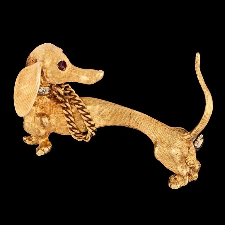 A gold and brilliant cut diamond dog brooch.
