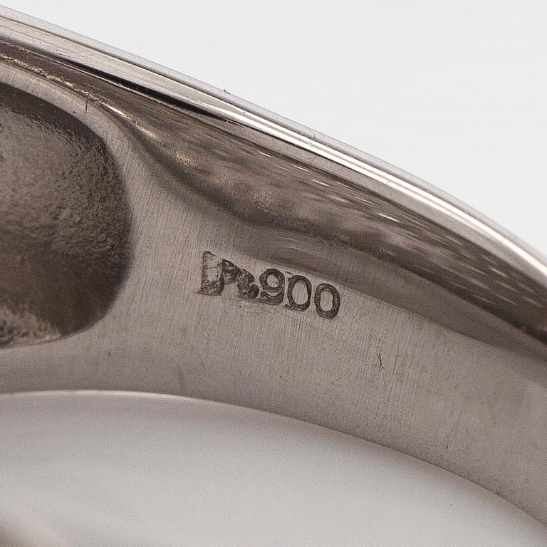 A platinum bombé ring with brilliant-cut diamonds.