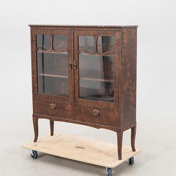 A 1920s  stained beech display cabinet.
