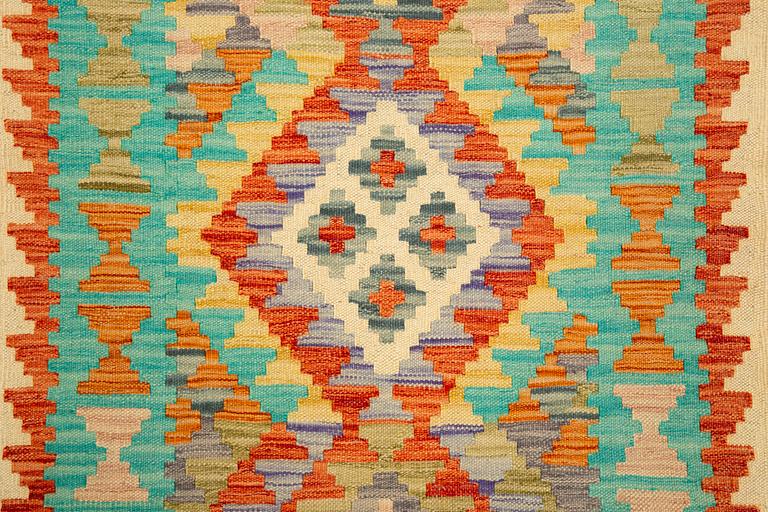 A kilim runner, c 300 x 85 cm.