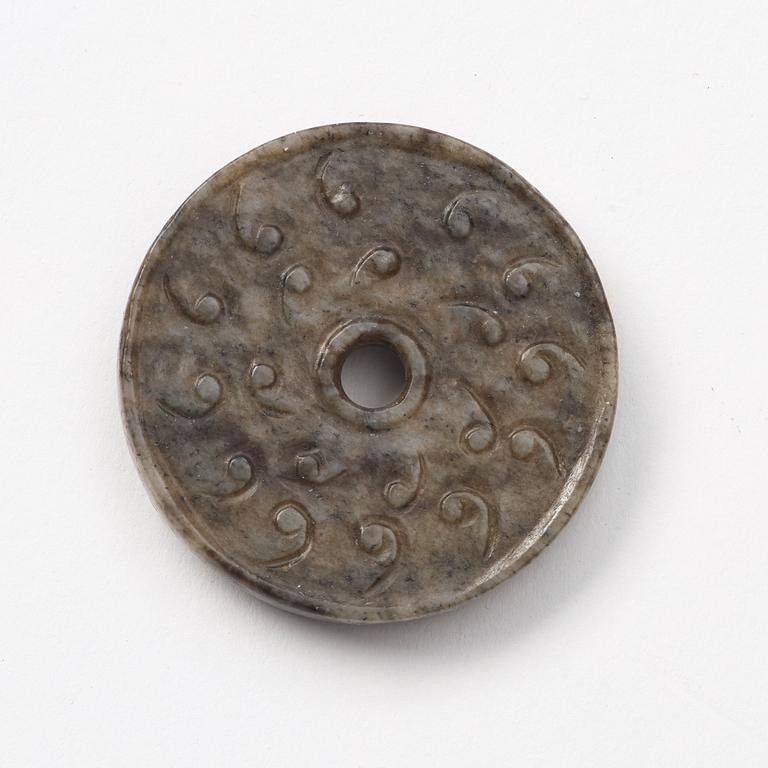 A group of three archaistic Chinese stone bi discs and two pendants.