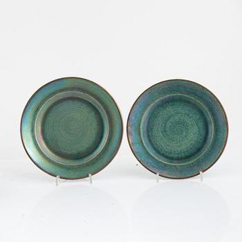Josef Ekberg, 11 ceramic side plates and a dish, Gustavsberg, 1920's.