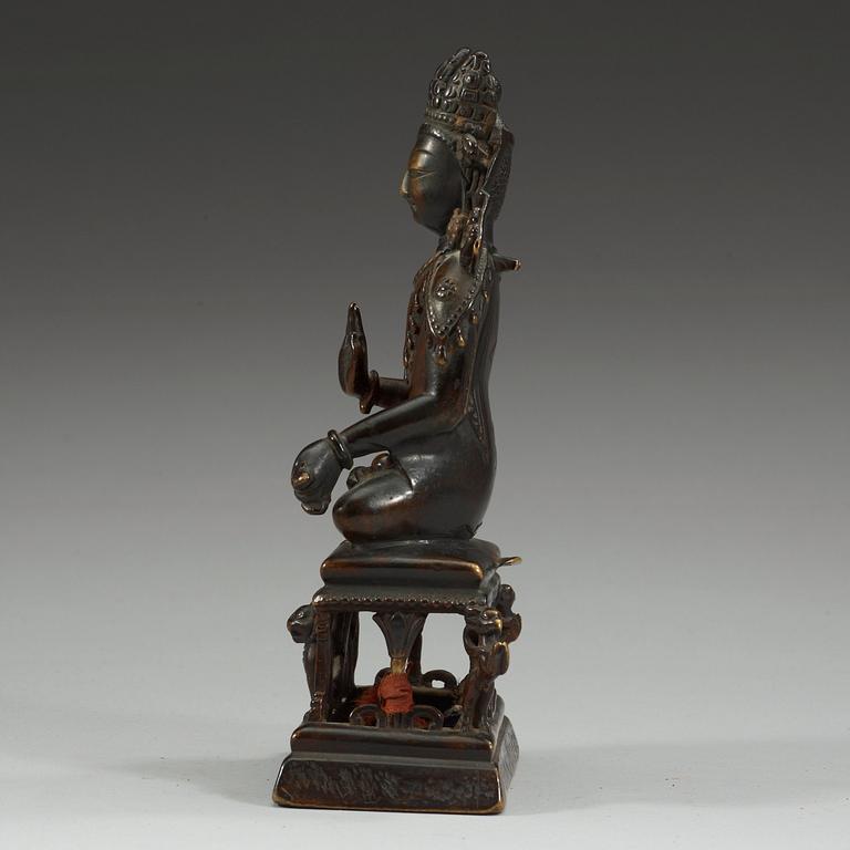 A western Tibetan/Kashmir bronze figure of Maitreya on a high throne, presumably 12th Century or older.