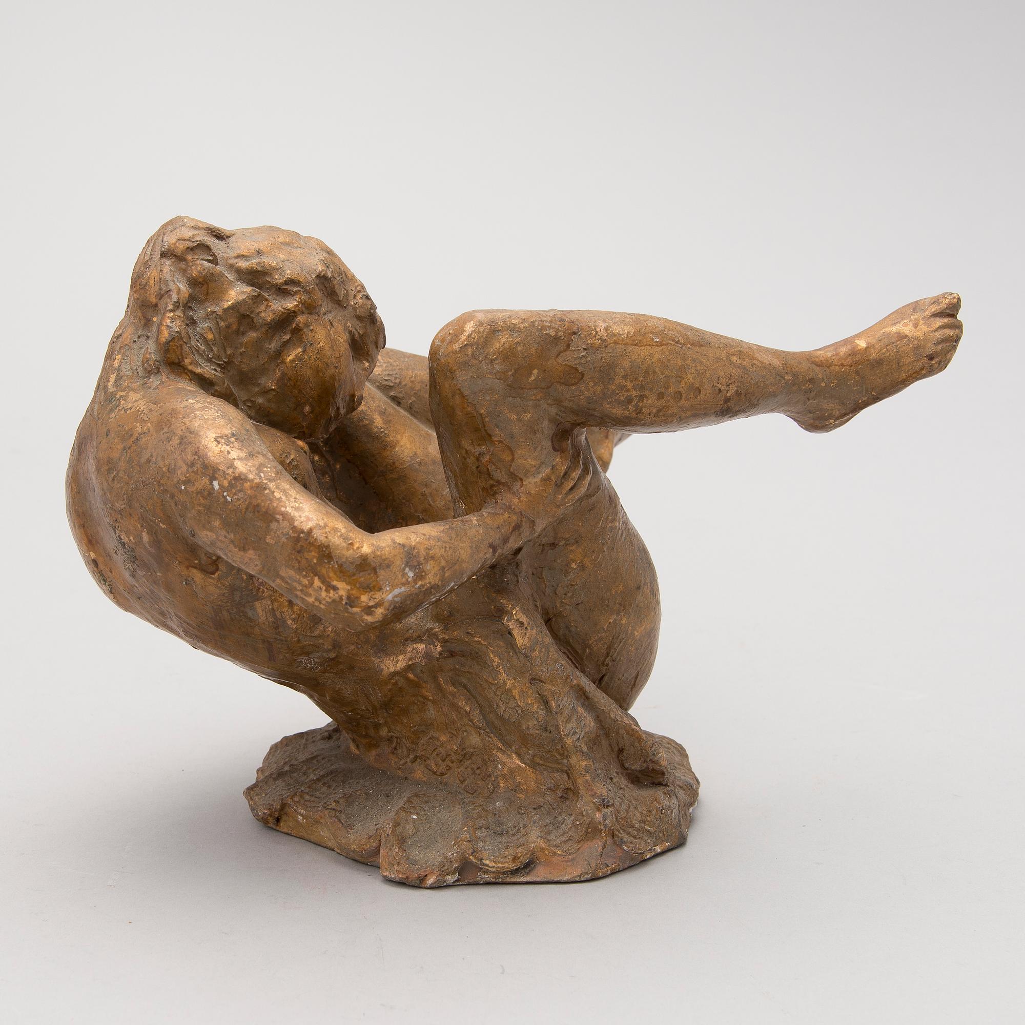 A gilt terracotta sculpture signed Matti Haupt.