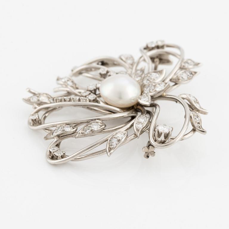 A brooch in palladium set with a half pearl and eight-cut diamonds, W.A. Bolin.