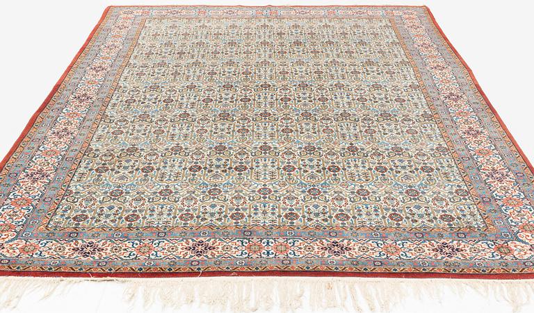 A carpet, semi-antique, Qum, ca 324 x 221 cm.