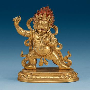1484. A Sinotibetan gilt bronze figure of a Dharmapala, Qing dynasty, presumably 18th Century.