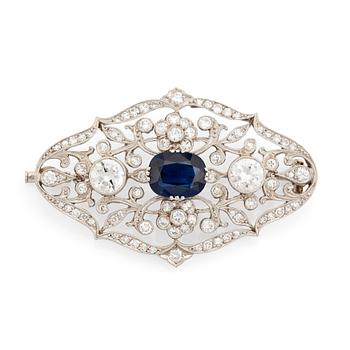 418. A platinum brooch set with a faceted sapphire and old- and eight-cut diamonds.