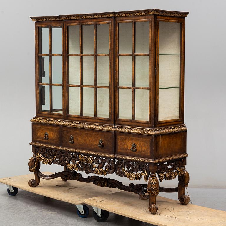 a baroque-style vitrine cabinet from the first half of the 20th century.