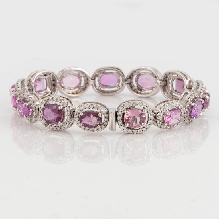 An 18K white gold bracelet set with faceted pink sapphires and round brilliant-cut diamonds.