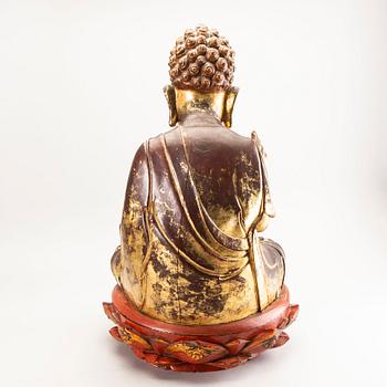 A large gilt and lacquered figure of a seated buddha, Qing dynasty, 19th Century.