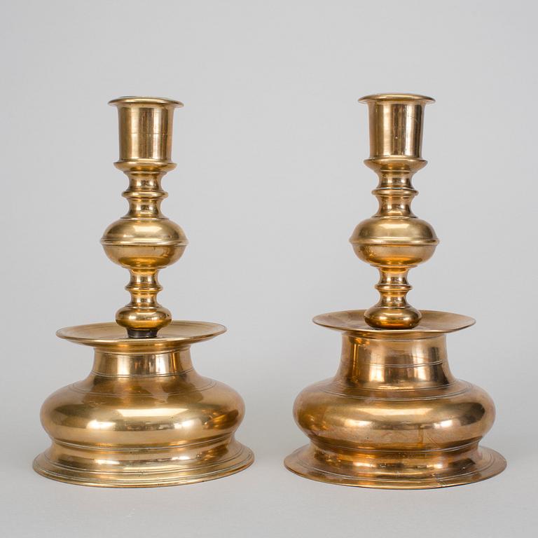 A set of two 18th century baroque brass candle sticks.