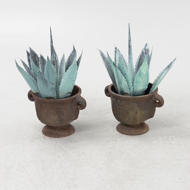 A pair of cast iron garden urns, 20th Century.