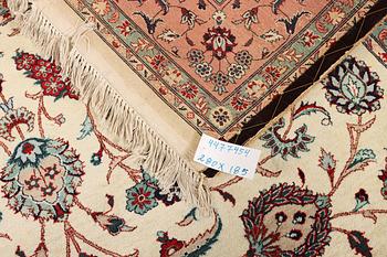 An oriental silk carpet, a. 280 x 185 cm.