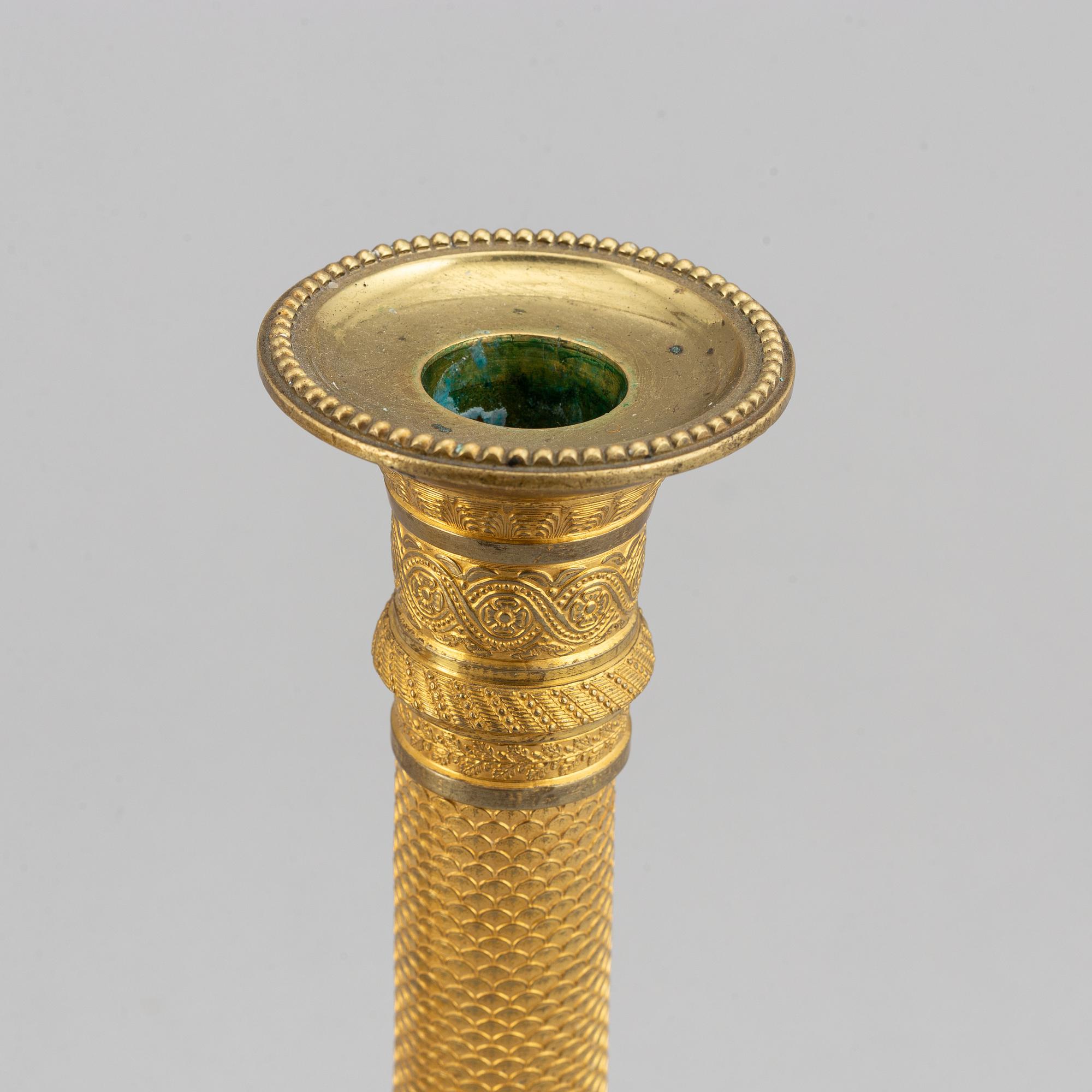 An early 19th Century pair of bronze empire candle sticks.