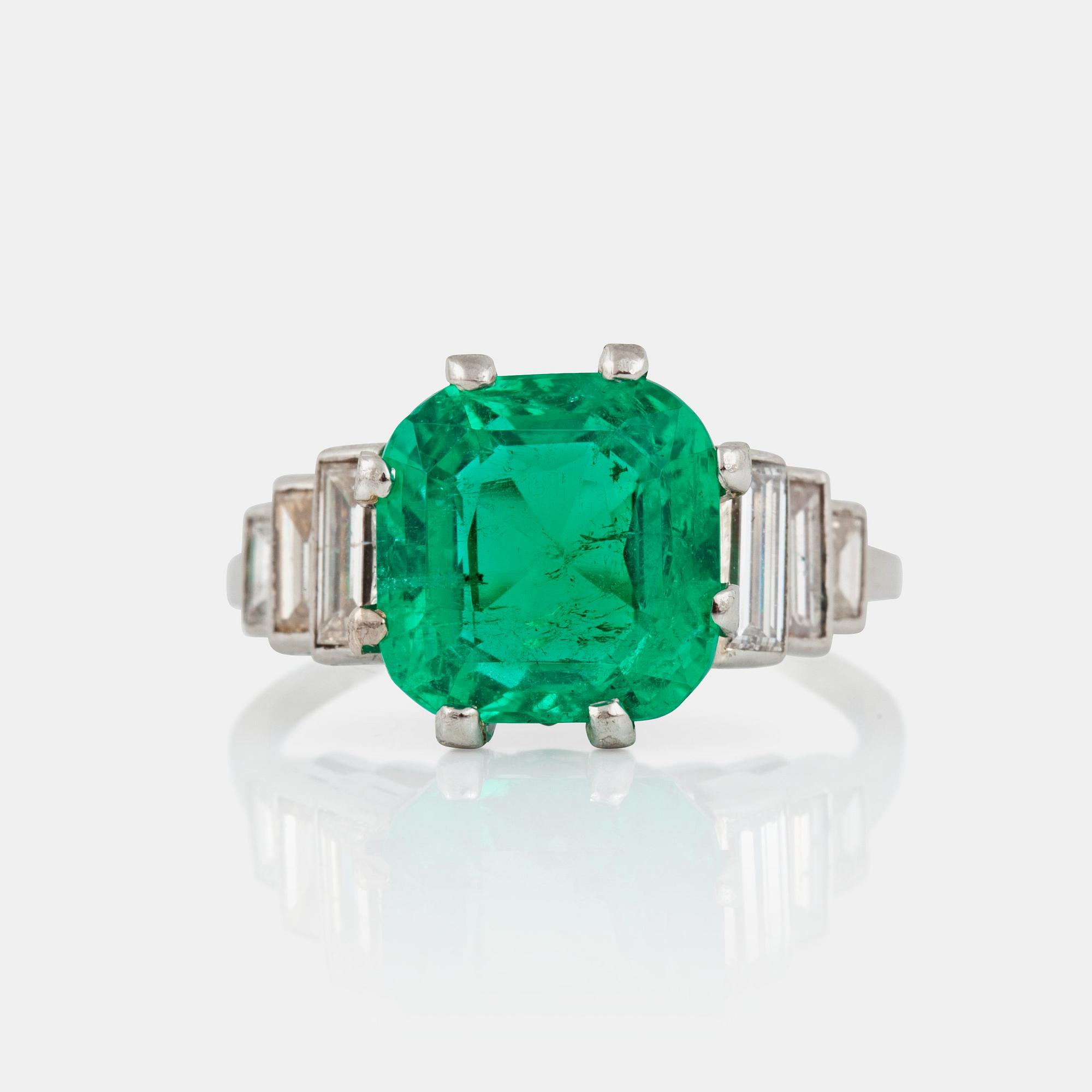 A cushion-shape mixed cut Colombian emerald, 4.56 cts, and baguette-cut diamond ring.
