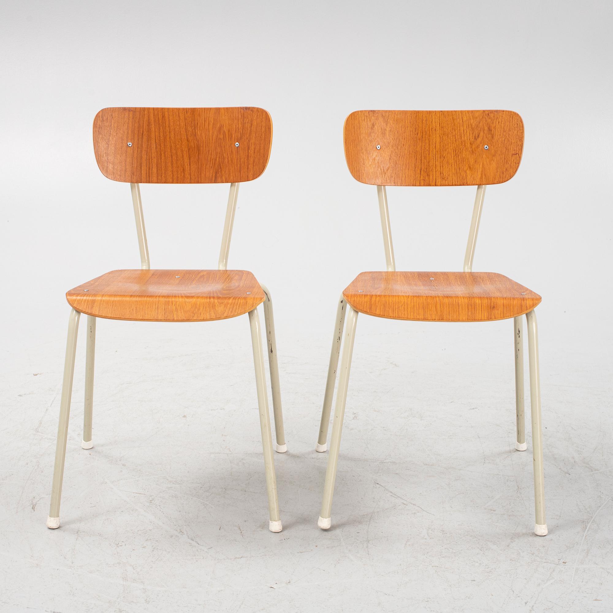Eight teak veneered chairs, second part of the 20th Century.