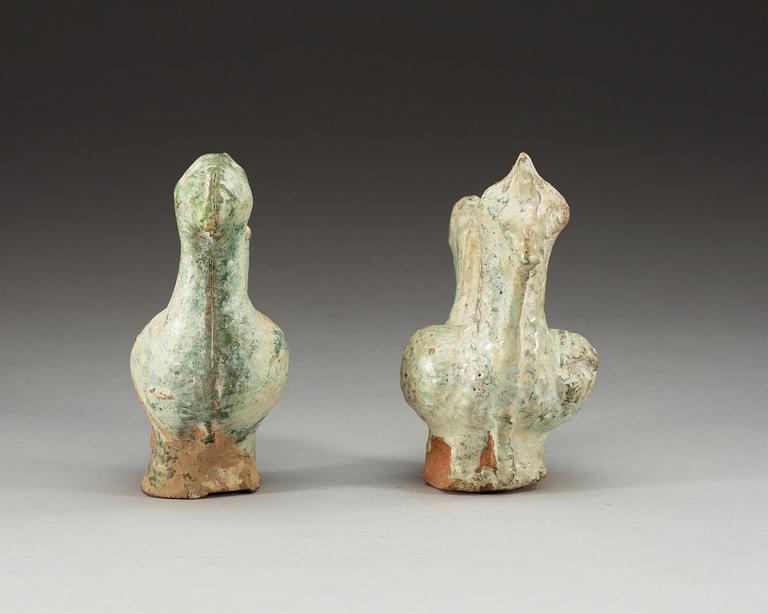 A set of two green glazed pottery models of a rooster and a hen, Han dynasty (206 BC- 220 AD).