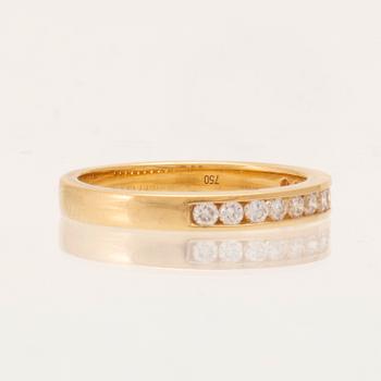 An 18K gold half-eternity ring set with round brilliant-cut diamonds.