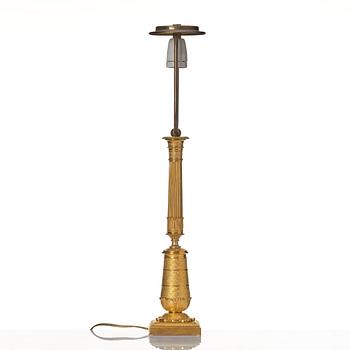 An gilded Empire table lamp.