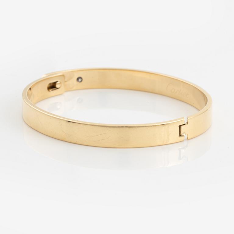 A Cartier "Anniversary Bracelet" in 18K gold set with a round brilliant-cut diamond.