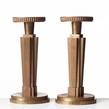 Lars Holmström, a pair of Swedish Grace patinated bronze candlesticks, Arvika, Sweden, 1920's-30's.