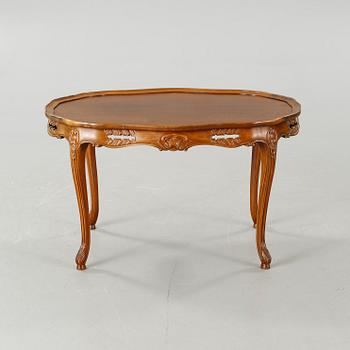 A rococo style sofa, two lounge chairs and a table, around the year 1900 and first half of the 20th century.