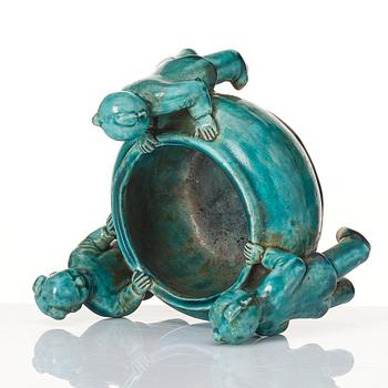 A turquoise glazed vessel supported by a group of boys, Qing dynasty, Kangxi (1662-1722).