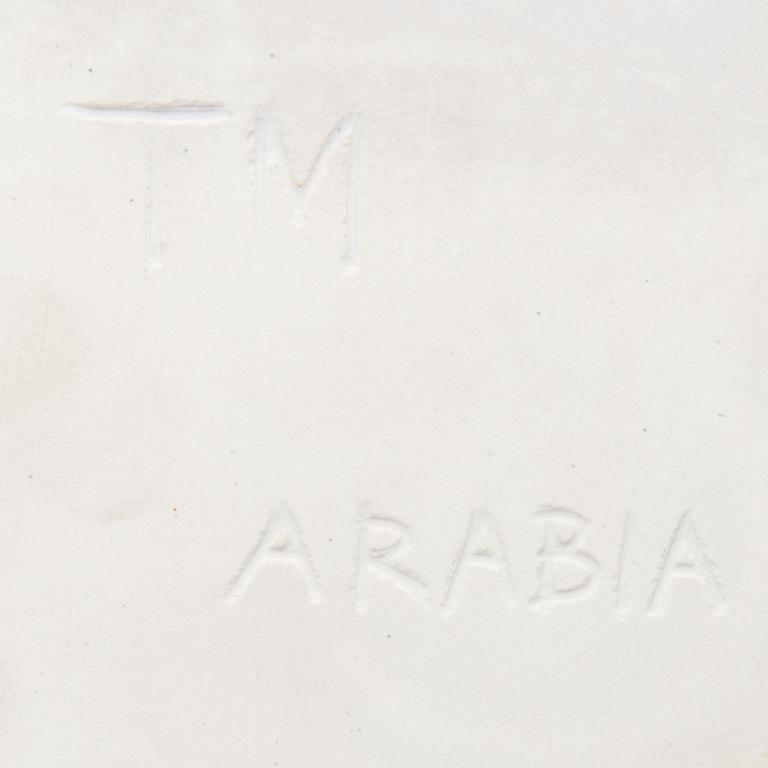 A ceramic art plate with leaf motif signed TM Arabia.