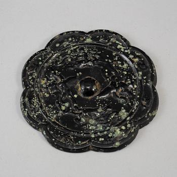 Eight-lobed bronze mirror with mythical animals, Tang dynasty (618–907). The pierced central knob cast with four Immortals riding a...