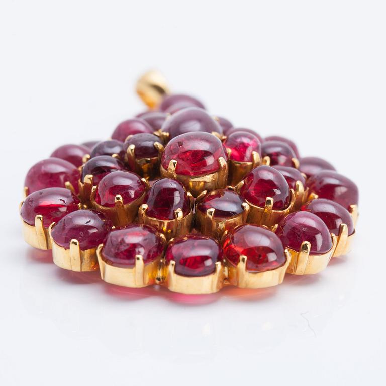 A cabochon-cut ruby pendant.