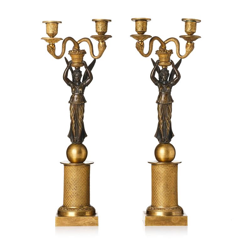 A pair of gilt and patinated bronze Empire-style two branch candelabra, later part 18th century.