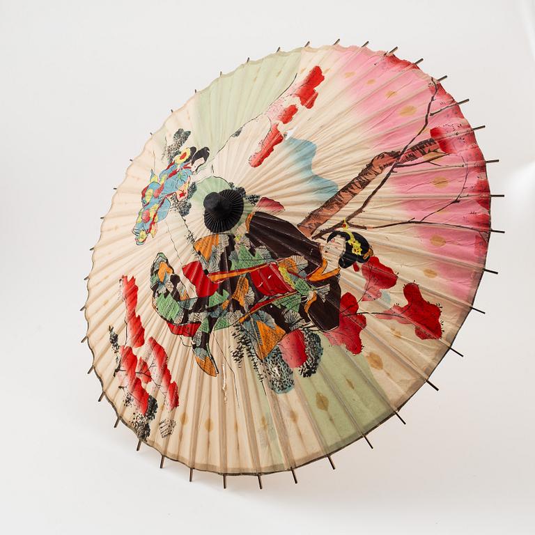 A set of six fans and two umbrellas and a wig/pony tail. Japan, early 20th Century.