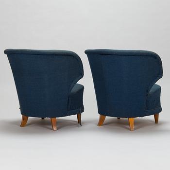 A pair of 1950s armchairs.