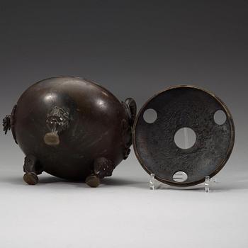 A bronze tripod censer with cover and stand, Qing dynasty, 17/18th Century.