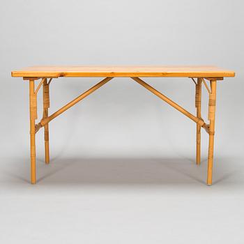 A pine wood and rattan table, late 20th century.