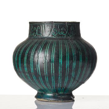 A Kashan Silhouette ware turquoise glazed pottery jug, central Iran, circa 1200.