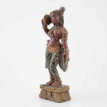 A wooden sculpture of a deity, Indian, 20th Century.