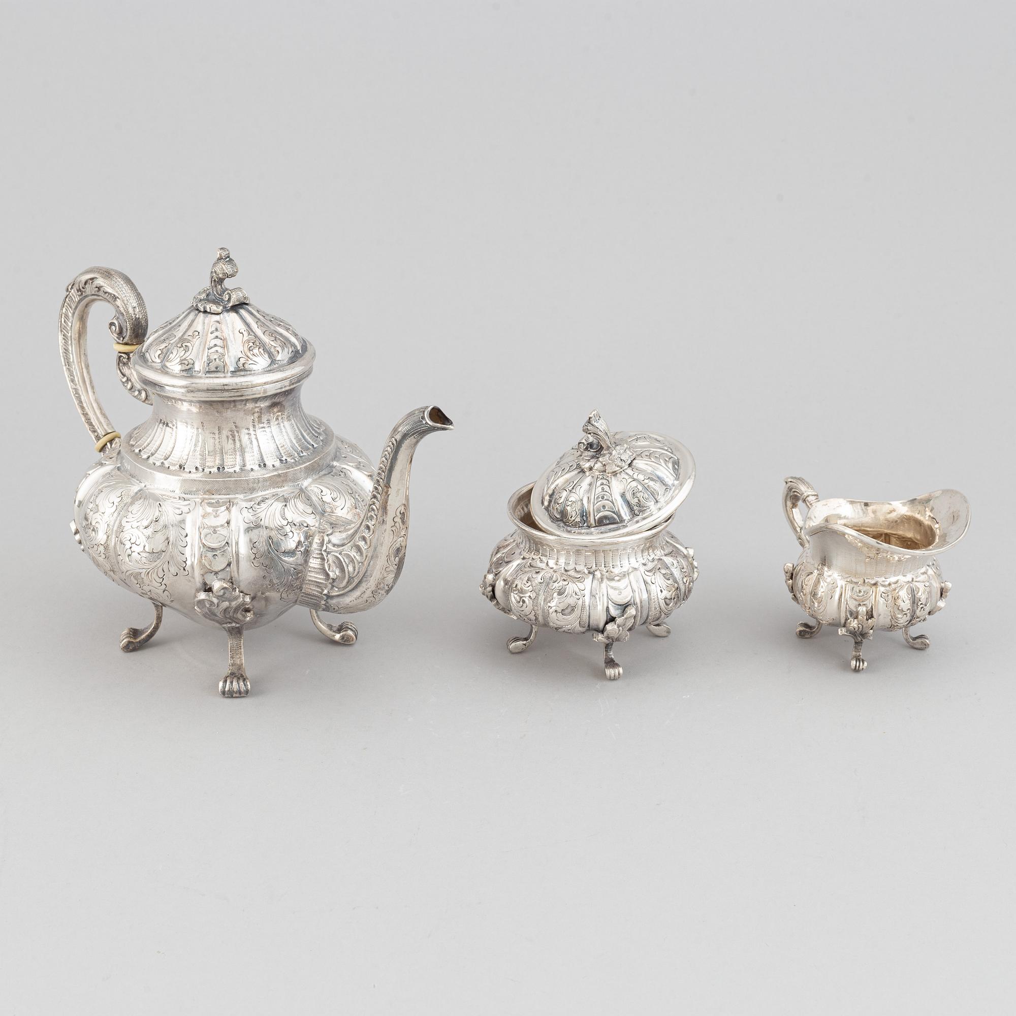 A silver teapot, creamer and sugar bowl, swedish import mark.