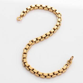 An 18K gold bracelet.