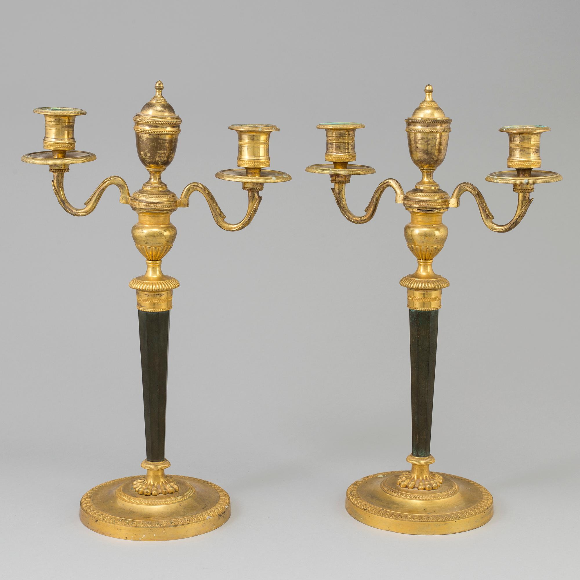 A pair of French Directoire late 18th century ormolu candelabra for three candles.