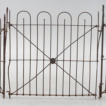 A pair of iron garden gates and a single gate from the early 20th century.
