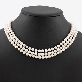 Pearl necklace, three strands of cultured pearls, clasp in 18K gold set with baguette and brilliant-cut diamonds.