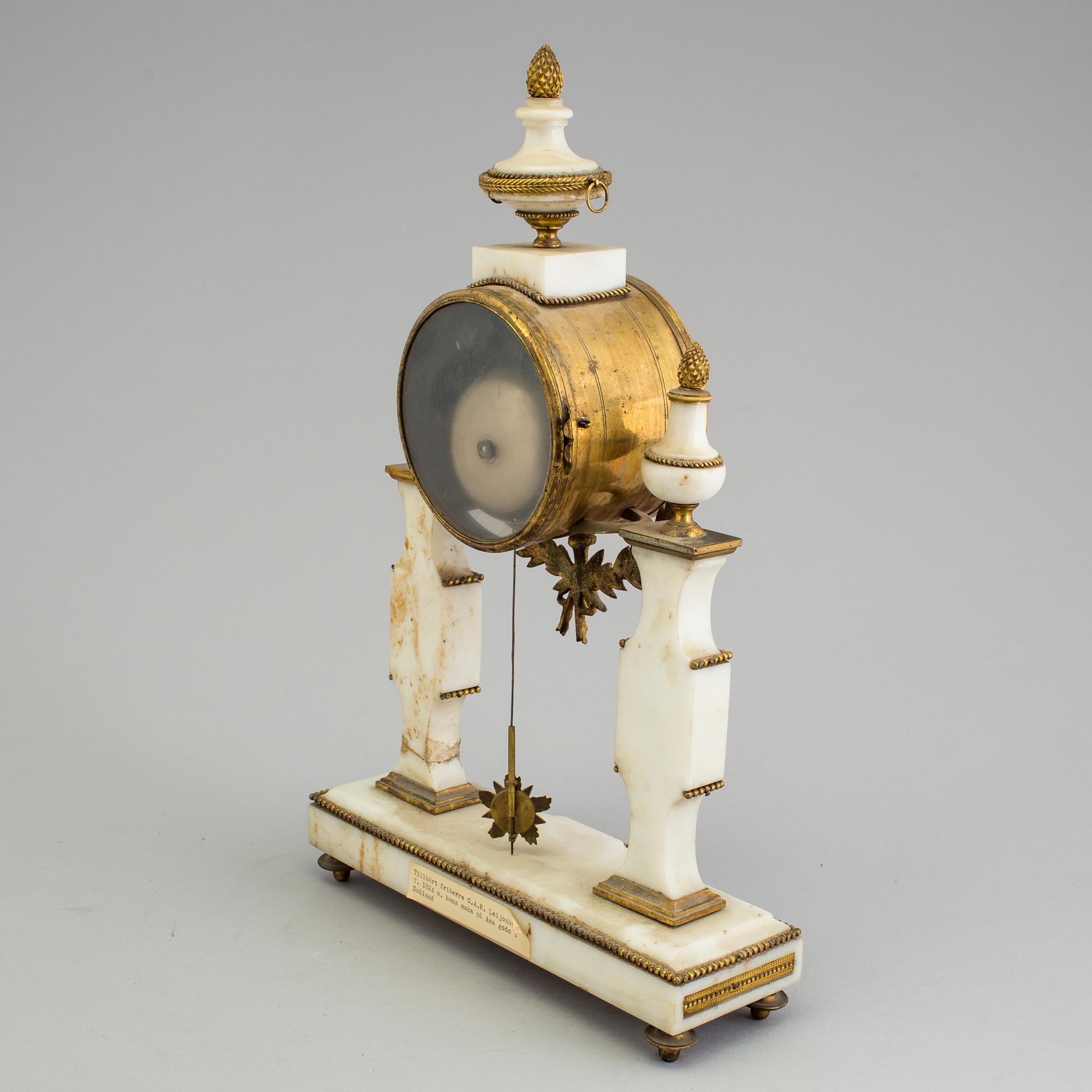 A Louis XVI marble and bronze mantel clock from the second half of the 18th century.