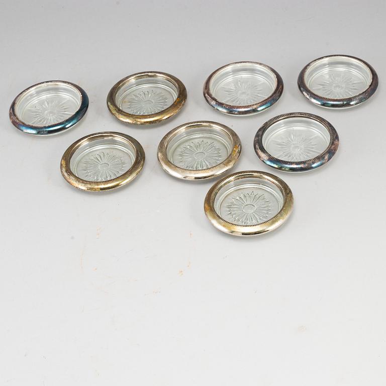 A set of eight glass and plate coasters, 20th century.